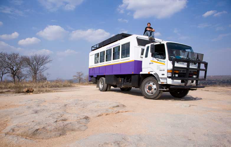 Overland truck at a viewpoint in Kruger National Park, South Africa. Image by / Lonely Planet Images / Getty Images