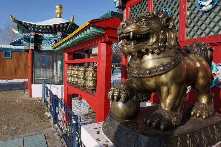 Bronze lion and prayer wheels at Ivolginsk Datsan near Ulan-Ude. Image by Anita Isalska / Lonely Planet