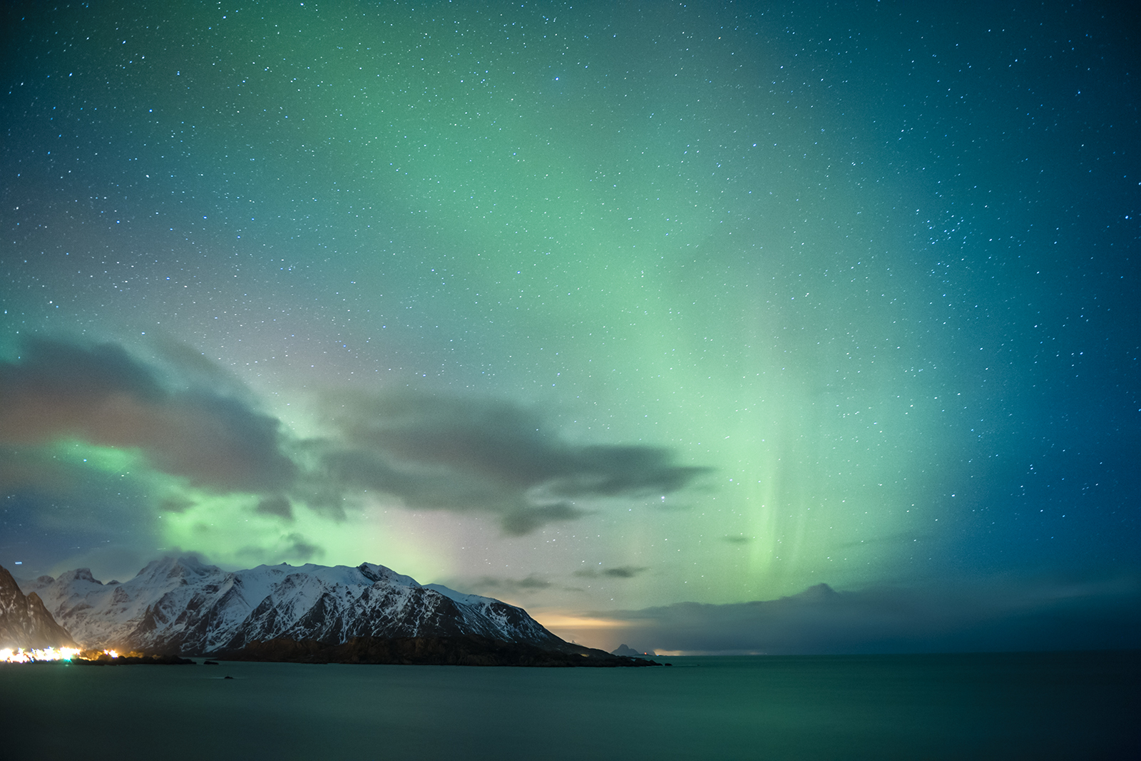 The northern lights, visible on clear nights for many of the winter months, swish across the sky near Reine.