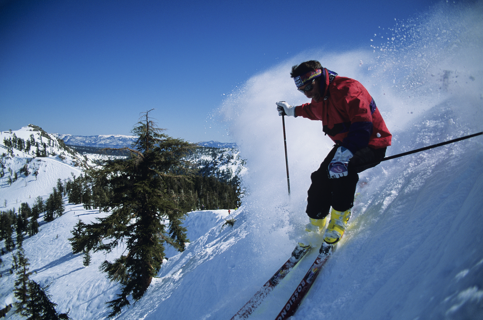 Skiing downhill in sunshine at Squaw Valley, California, USA