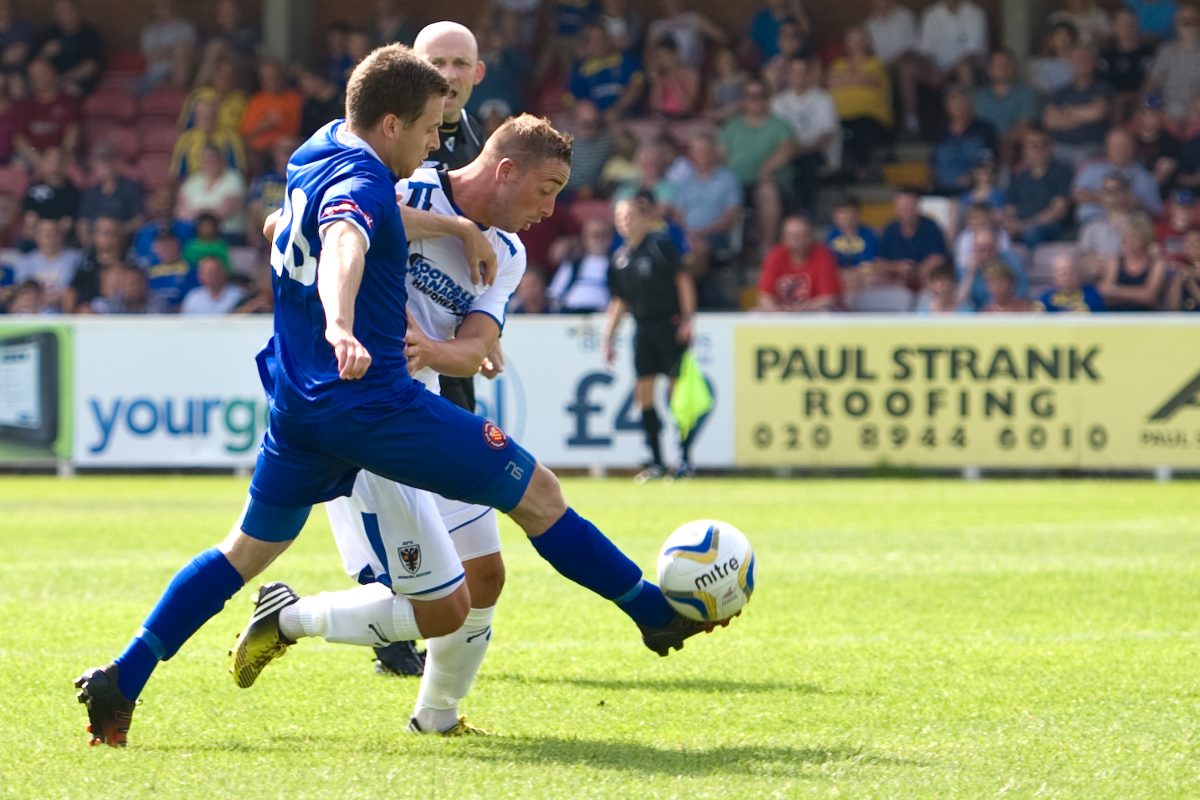 AFC Wimbledon and FC United compete for possession. Image by Matthew Wilkinson / CC BY 2.0