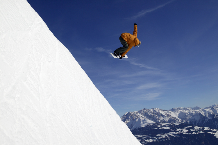 Snowboarder jumping at Crap Sogn Gion, Laax. Image by Ulli Seer/Photostock Getty.
