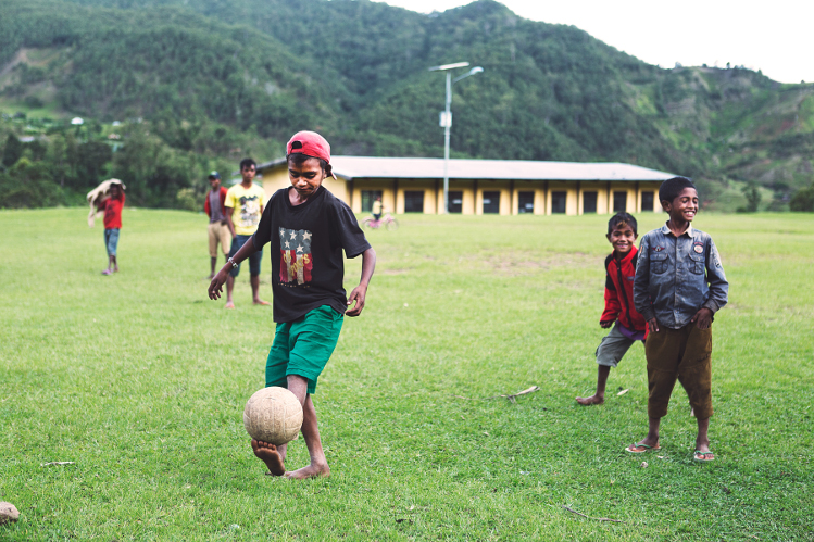 Children paly soccer in the village of Hatobuilico, near the trail head of Mt Ramelou