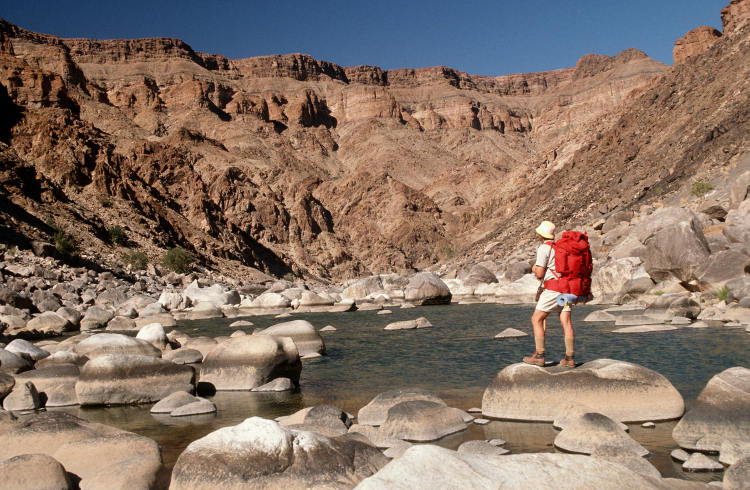 A hiker admiring 1.5 billion years of geologic history. Image by Hein von Horsten / Getty Images