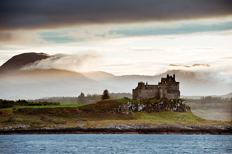 Duart Castle on Mull emerges from the mist. Image by Gregory Heath / Moment / Getty Images