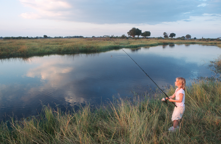 Child fishing in Botswana