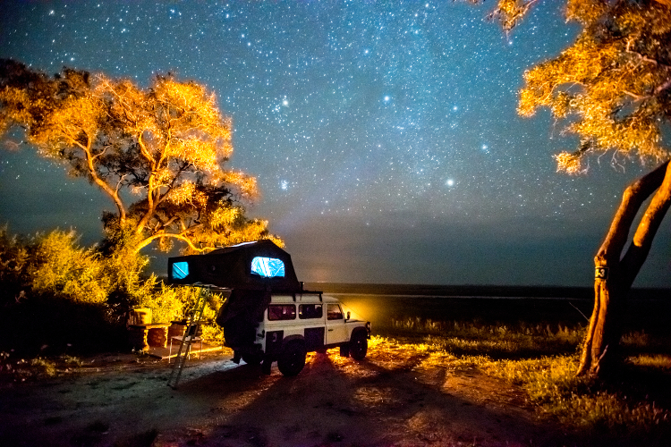 Self-drivers camping beneath the southern sky, Botswana. Image by Edwin Remsberg / Getty Images