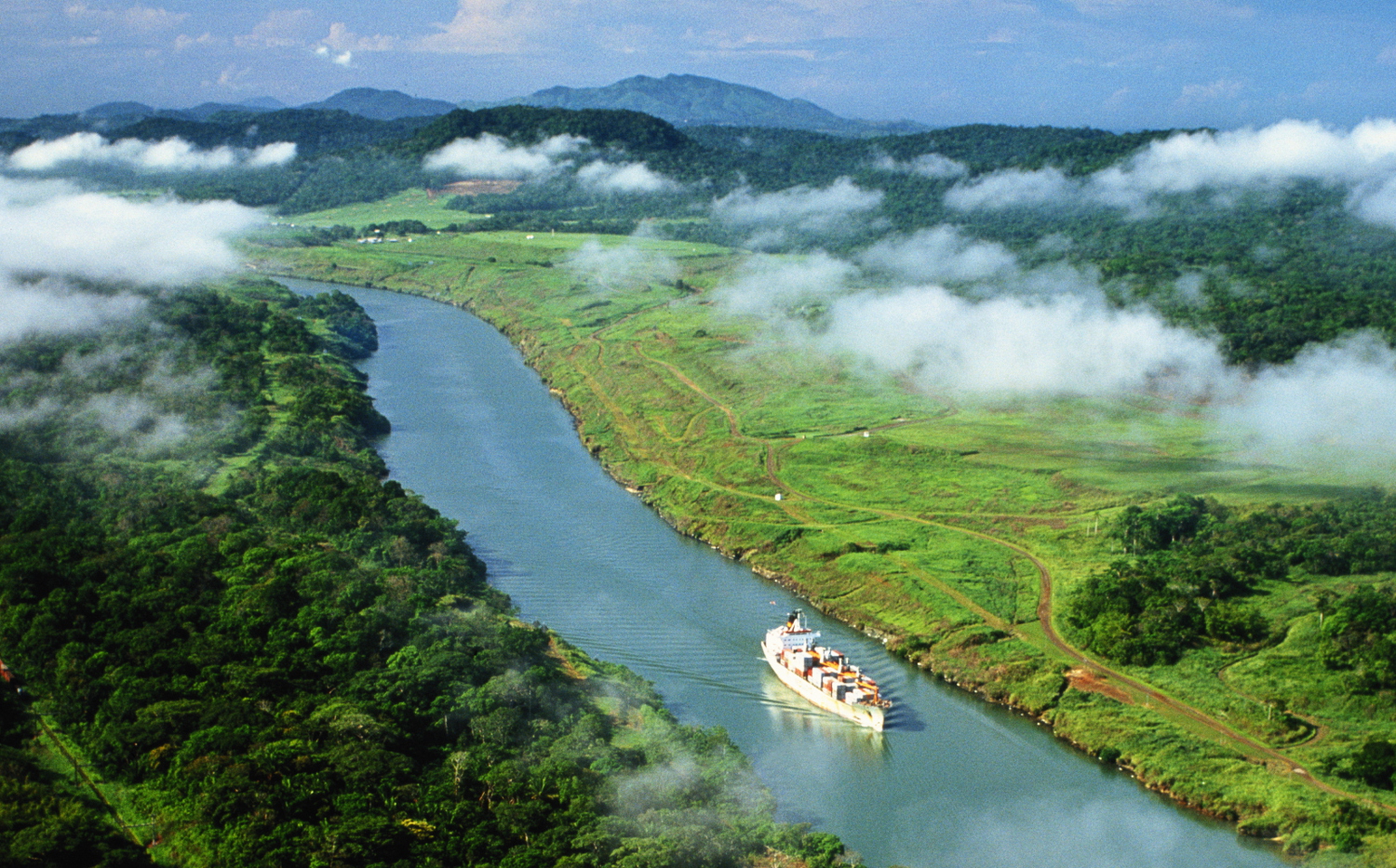 Massive container ships dwarf the canal landscape. Image by Will &amp; Deni McIntyre / The Image Bank / Getty