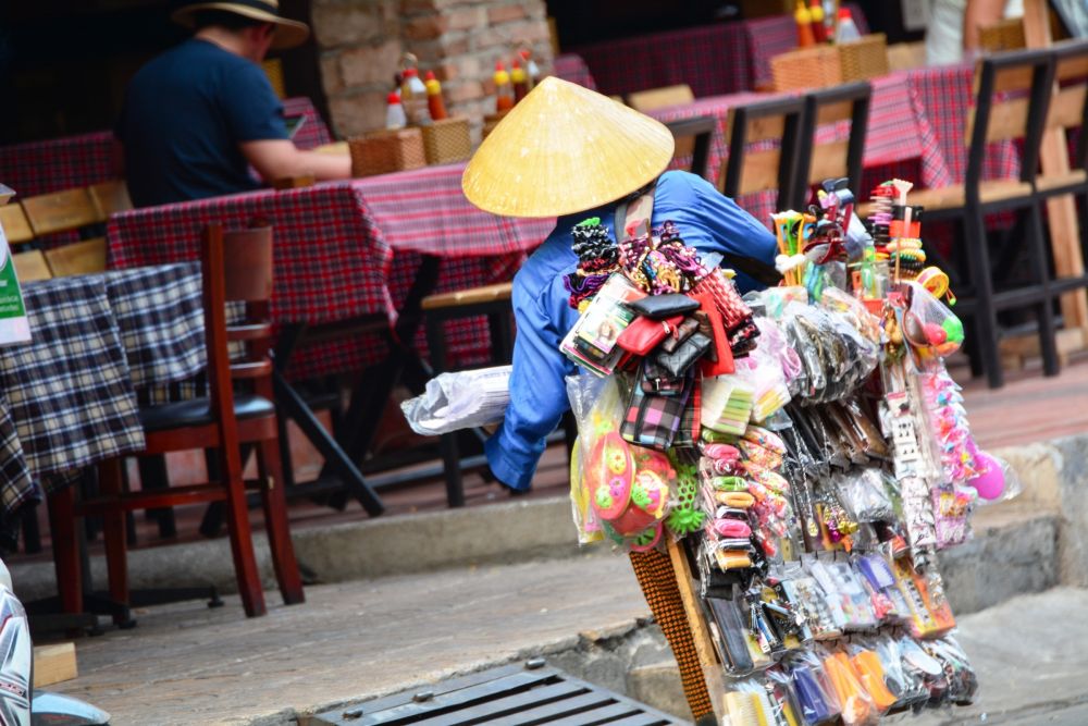 A street seller wanders along Bui Vien St.