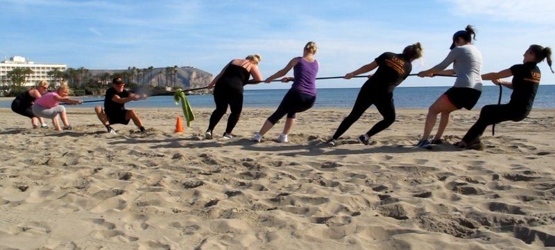 La Vida Boot Camp play tug of war on Javea Arenal beach