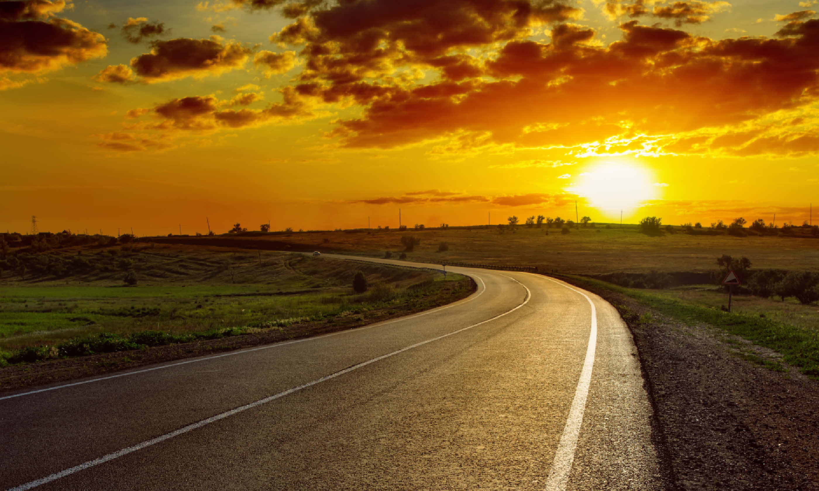 Sunset over asphalt road (Shutterstock)