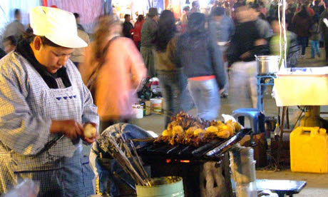 Anticuchos are served after-dark on skewers with potatoes (Flickr: lilap)