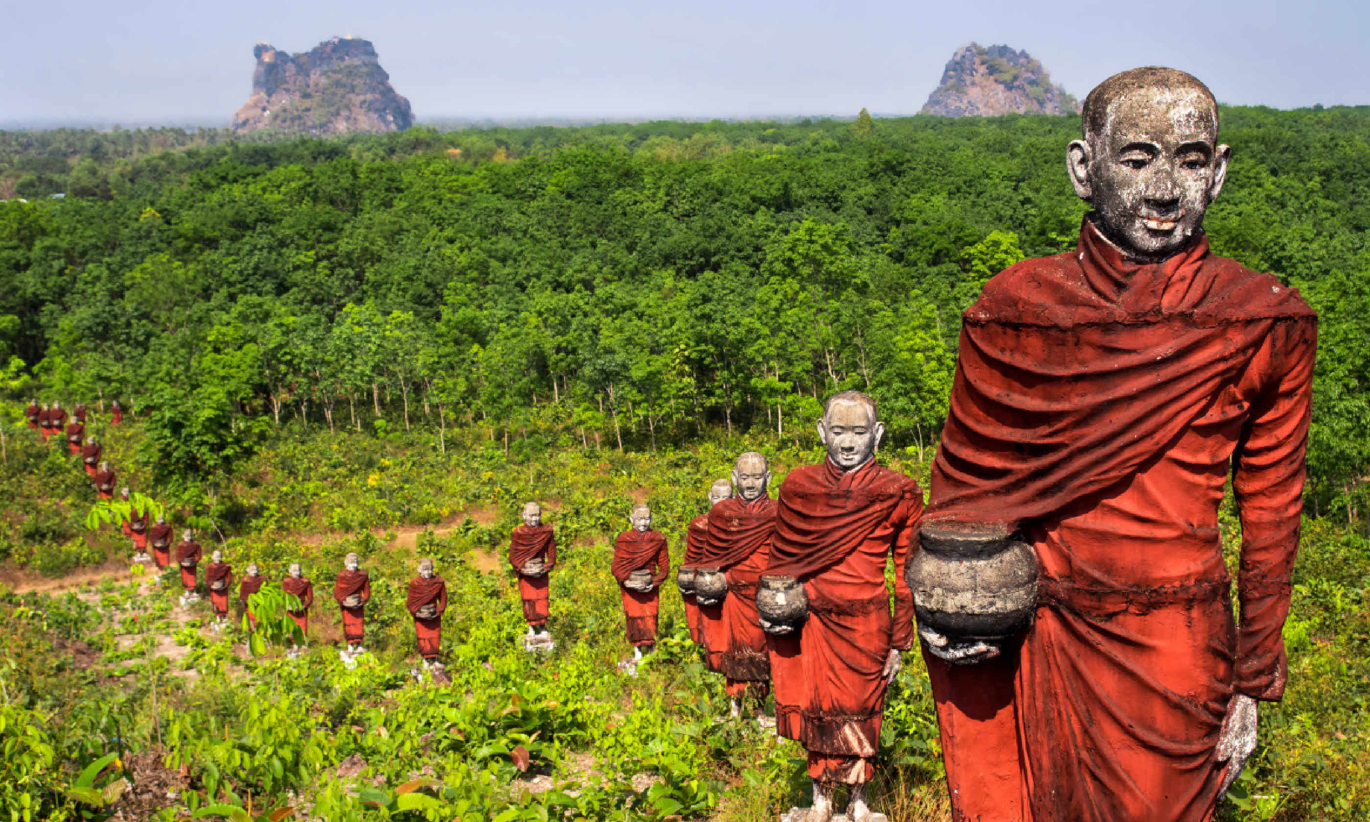 Statues of Buddhist monks collecting alms (Shutterstock: see credit below)