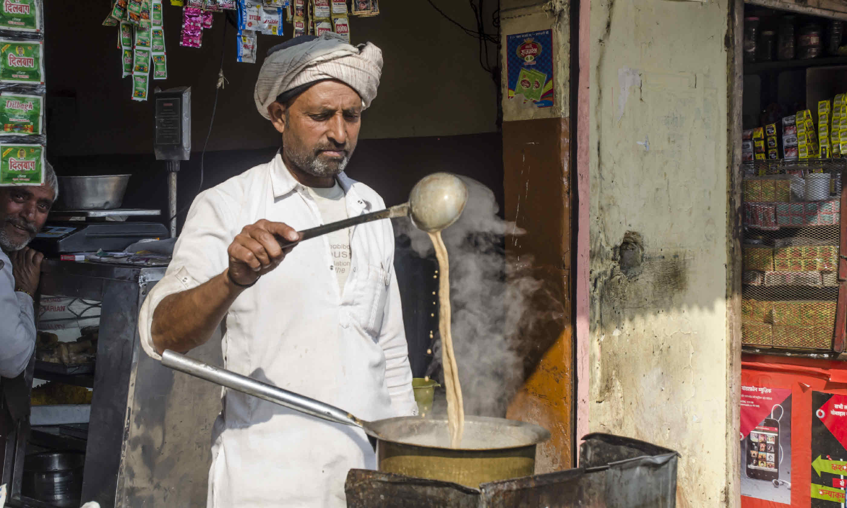 Man making Indian tea (Shutterstock)