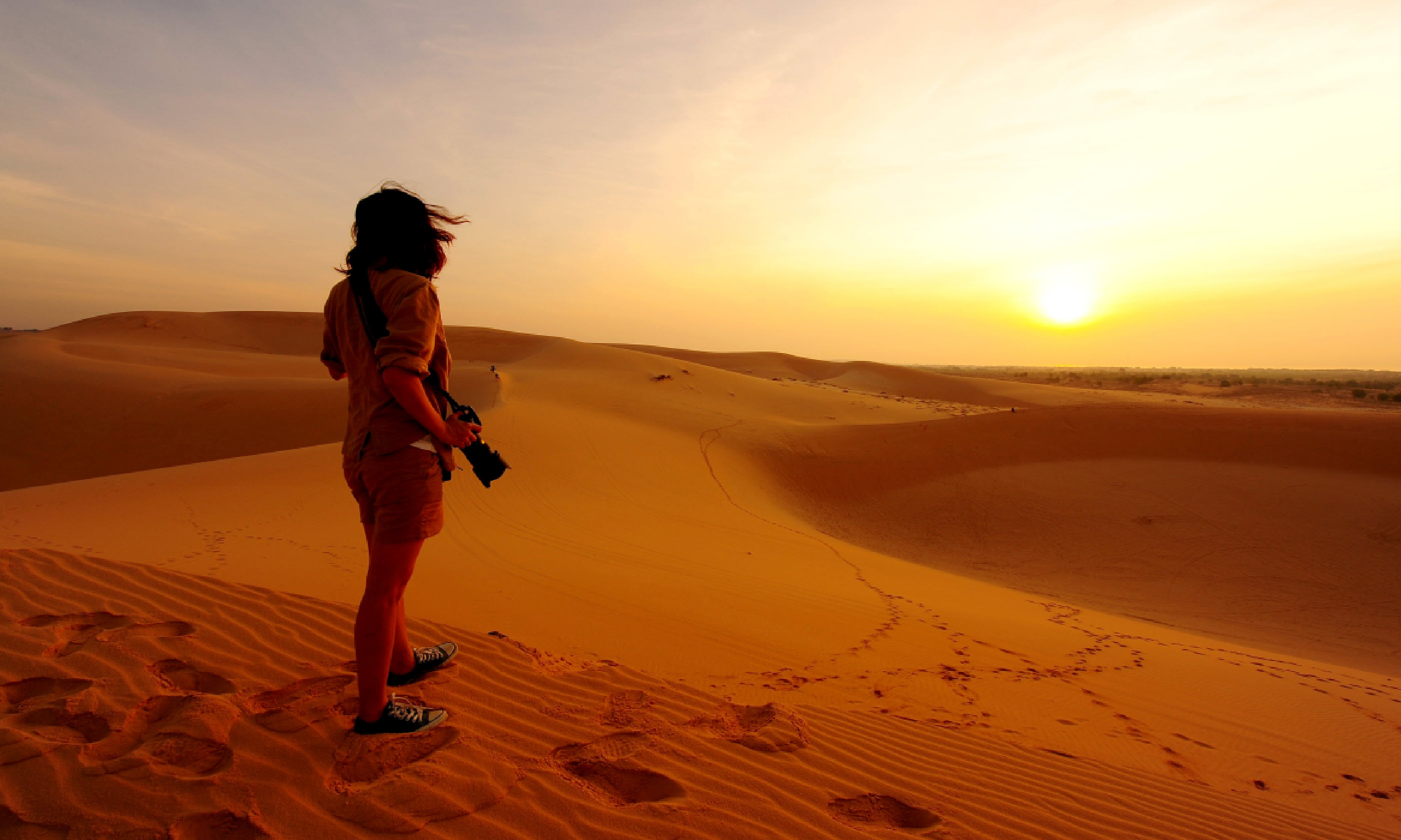 Photographer in the desert (Shutterstock: see credit below)