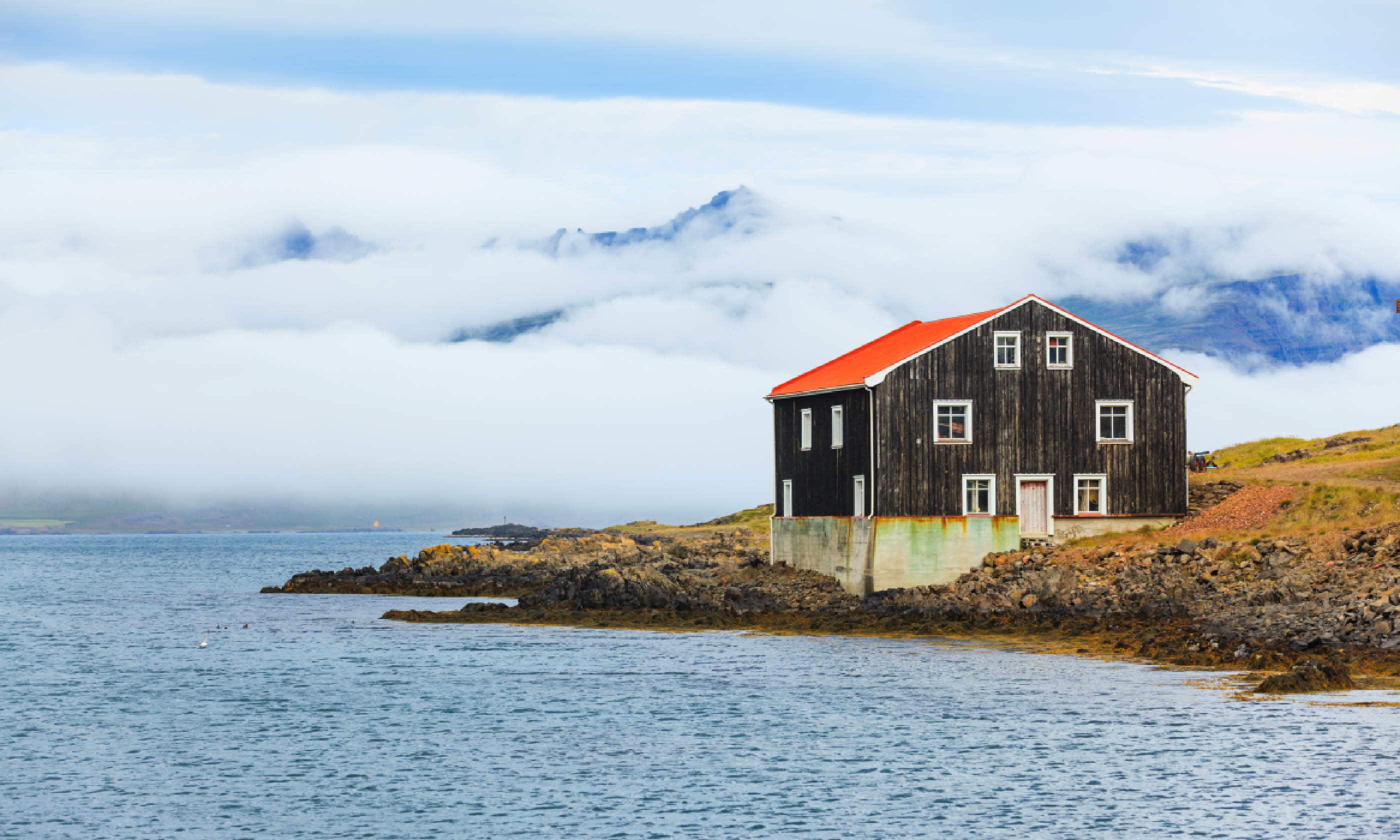Black Wooden House at coastline in East Iceland (Shutterstock)