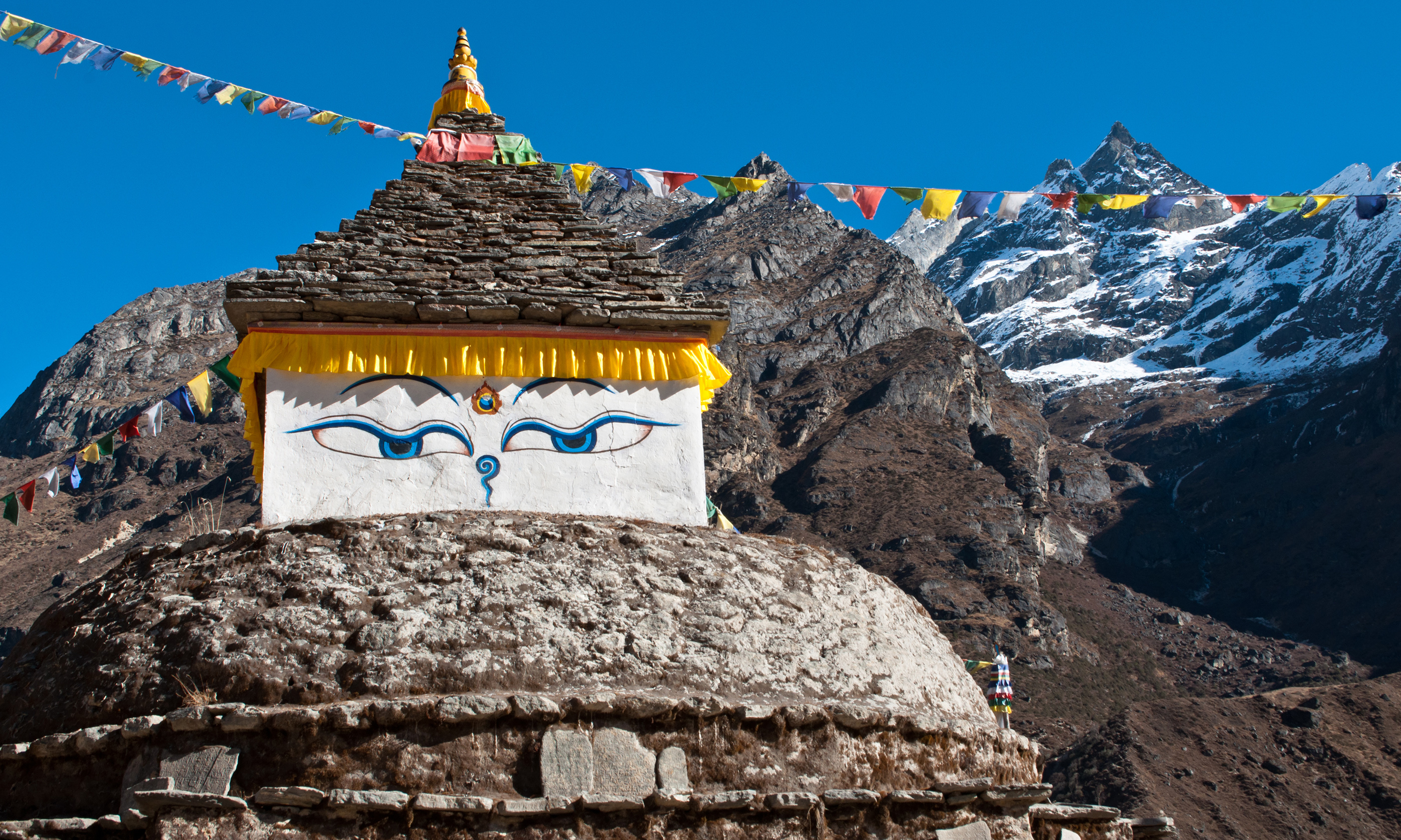 Prayer flags and a temple (Shutterstock.com)