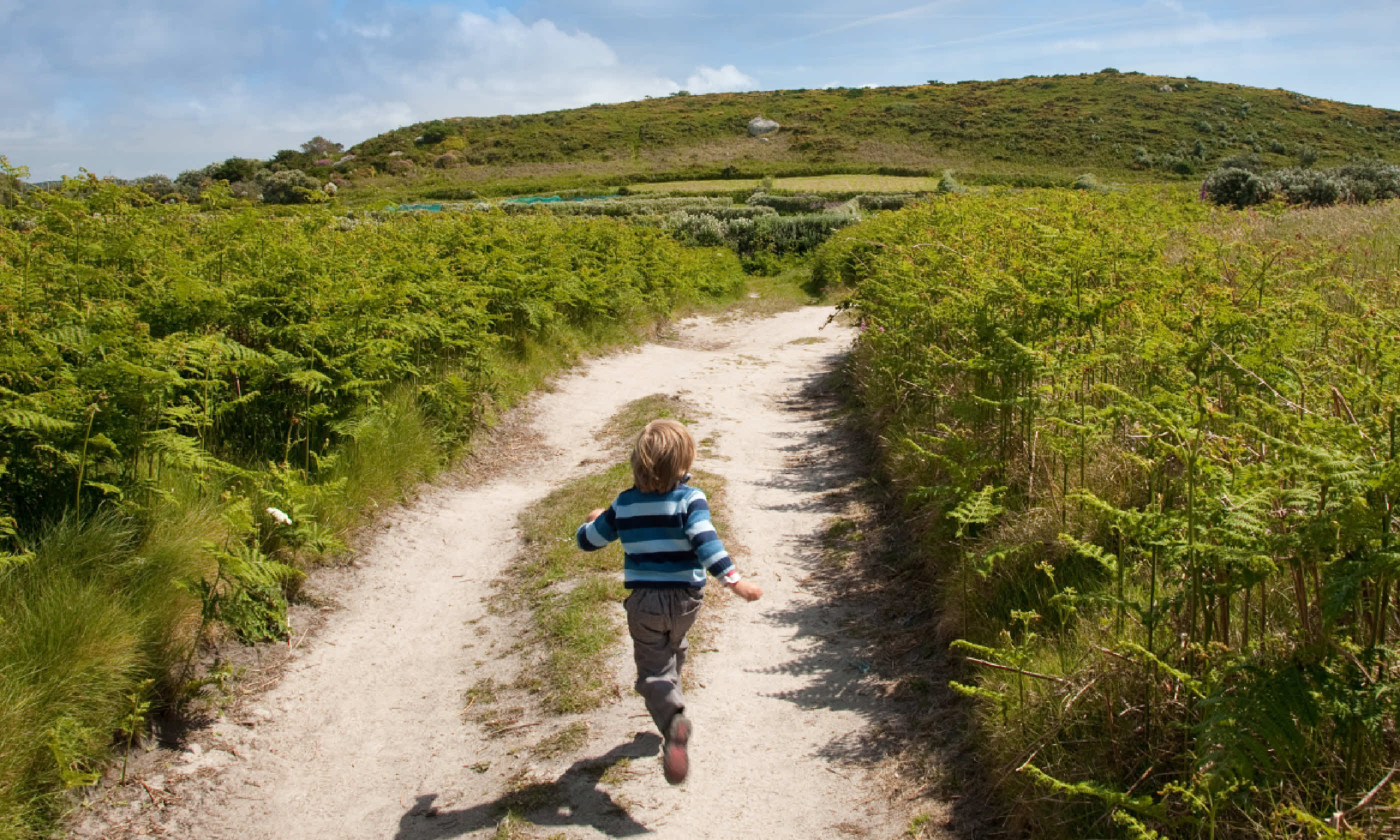 Child running on holiday in England (Shutterstock: see credit below)