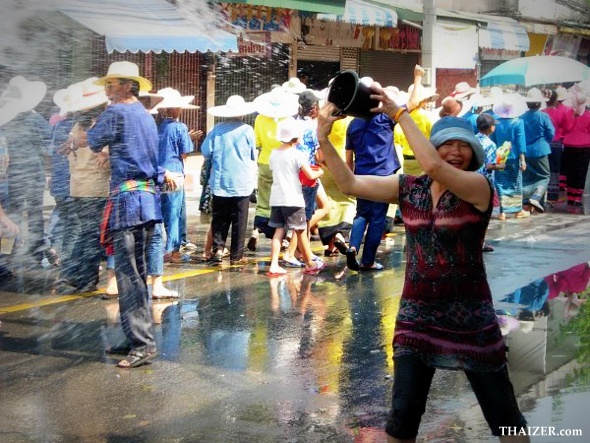 Throwing buckets of water during the Songkran New Year Water Festival