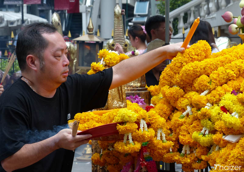 making an offering at the Erawan Shrine, Bangkok