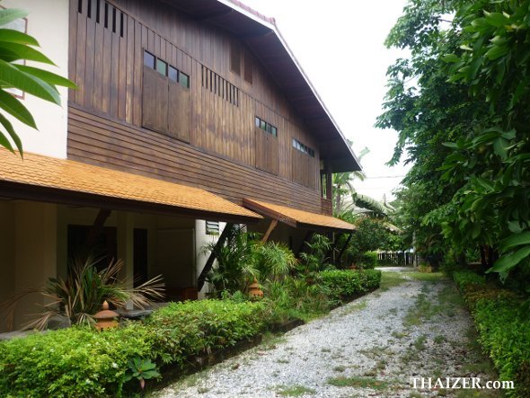 side view of At Home Sukhothai showing garden rooms with covered terrace and upstairs wooden rooms