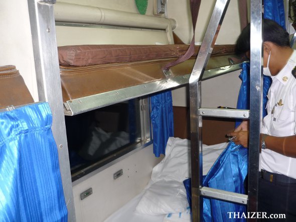 State Railway of Thailand staff make up the sleeping bunks