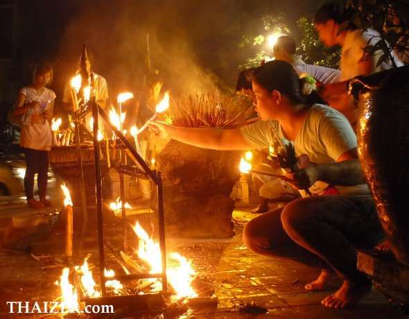 lighting candles and making merit at Wat Chedi Luang in Chiang Mai