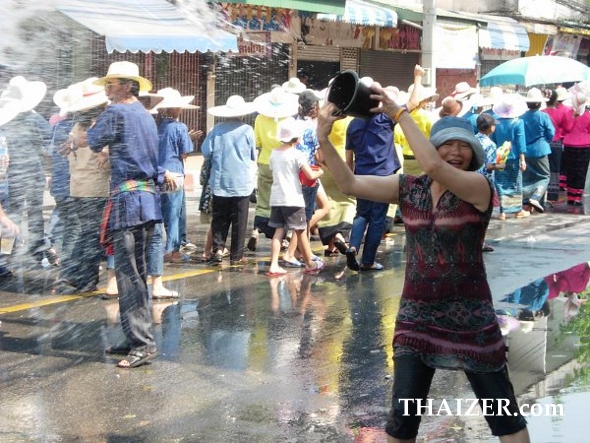 Throwing buckets of water during the Songkran parade