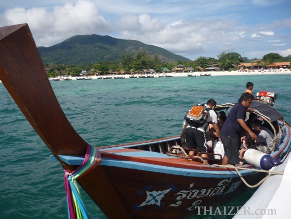 Transferring from speedboat to longtail boat on arrival at Ko Lipe, Thailand
