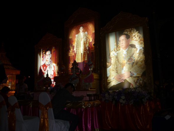 A  Thai well-wisher signs the book of goodwill in honour of His Majesty the King