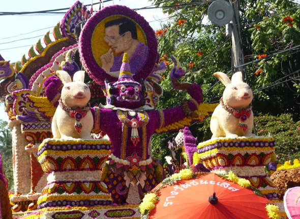 Float at Chiang Mai Flower Festival with floral portrait of King of Thailand and his birth-year animal, the rabbit