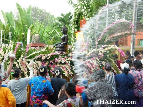 throwing water over Buddha statues for Songkran