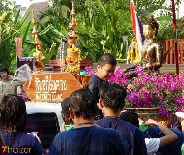 Pouring water over Buddha images during Songkran