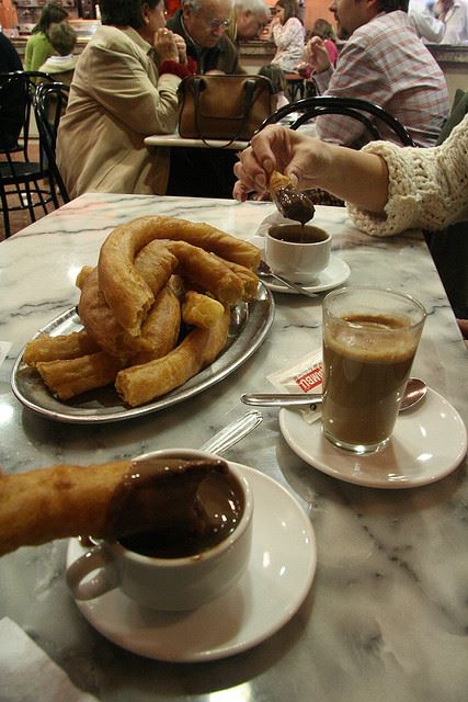 churros chocolate sharing food table spain