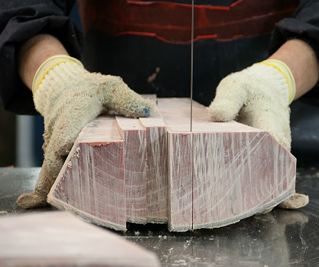 Frozen tuna in a bandsaw