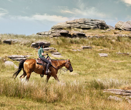 Riding past granite tors on Dartmoor