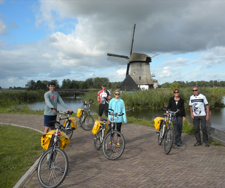 Cycling by a windmill in Holland