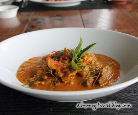 Beef Panaeng curry garnished with Thai basil leaves