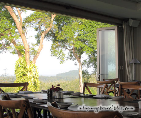 A dining room and a wide open French window