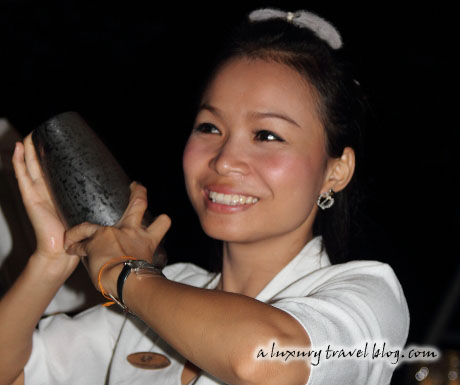 A Thai mixologist shakes a cocktail