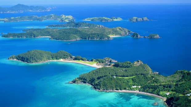 The warm, azure waters and sandy beaches of the Bay of Islands beckon.