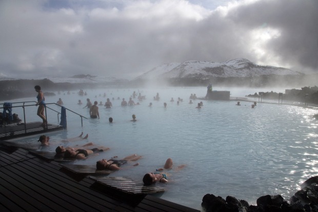 Guests relax in geothermal seawater in the main lagoon at the Blue Lagoon spa in Grindavik, Iceland.
