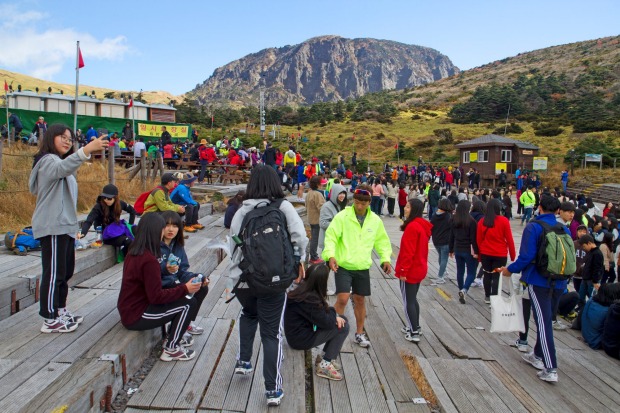 Crowds on the slopes of Hallasan: the flight from Seoul to Jeju Island, where Hallasan is the unavoidable centrepiece, ...