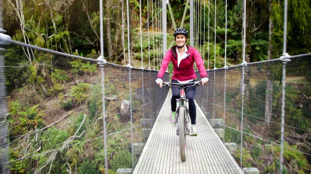 Megan Gale crossing the impressive Maramataha Suspension Bridge on The Timber Trail. Some of New Zealand’s highest and ...