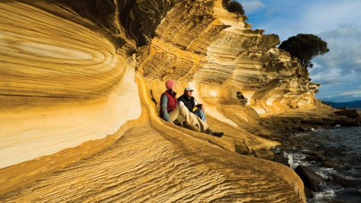 Hikers near Painted cliffs, on Maria island.