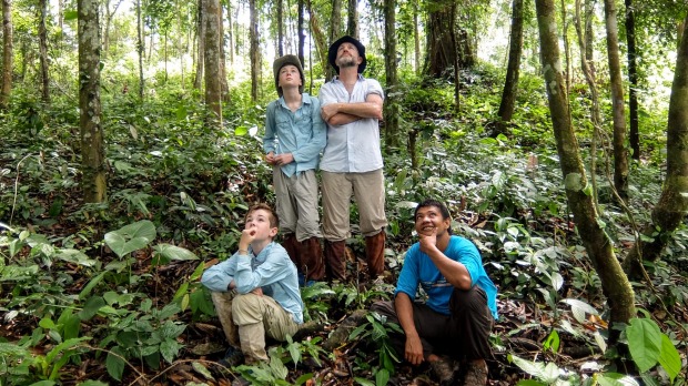 Seeing Orangutans in the wild with jungle guide Udin. Pictured, clockwise from back left, Tom, Chris, Udin and Kit.