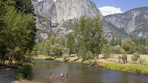 Cooling off in the Merced River beneath the dry wall of Yosemite Falls.