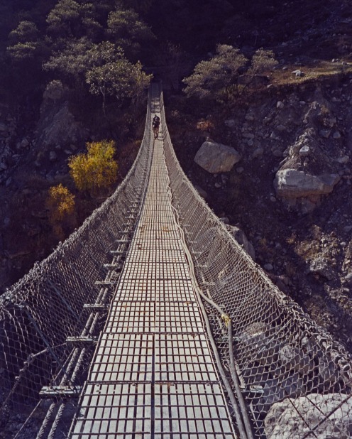 The wire rope suspension bridge over Kali Gandaki river at Ghasa on Annapurna circuit Himalayas Nepal.