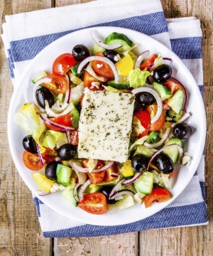Greek salad of organic vegetables with tomatoes, cucumber, red onion, olives and feta cheese.