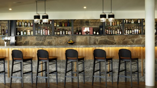 Guests gather at the Driftwood Bar to cool off after a day at the beach.